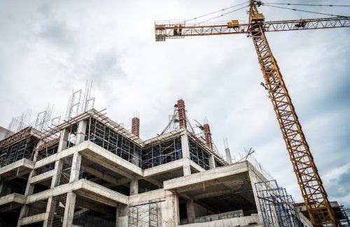 45964319 - crane and building construction site ( filtered image processed vintage effect. )